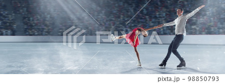 Two professional sportsmen, man and woman, figure skaters showing graceful performance on 3D arena, ice rink 98850793
