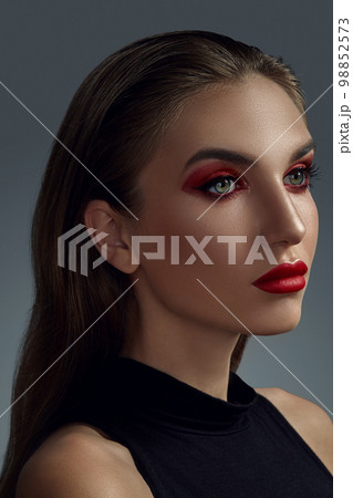 Close-up portrait of a beautiful fashion model with professional make-up. 98852573