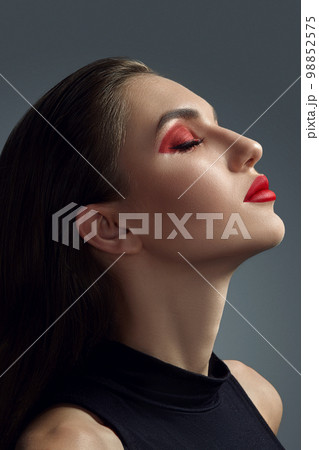 Close-up portrait of a beautiful fashion model with professional make-up. 98852575