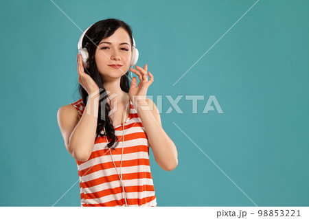 Studio photo of a gorgeous girl teenager posing over a blue background. 98853221