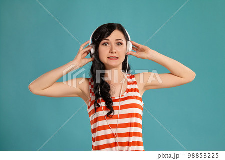 Studio photo of a gorgeous girl teenager posing over a blue background. 98853225