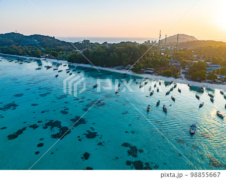 Aerial view of Sunrise beach with long tail boats in Koh Lipe, Satun, Thailand Aerial view of Sunrise beach with long tail boats in Koh Lipe, Satun, Thailand 98855667