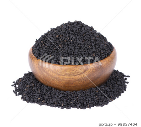 Black cumin seeds in wooden bowl, isolated on white background. Heap of black nigella seeds. Nigella sativa. 98857404