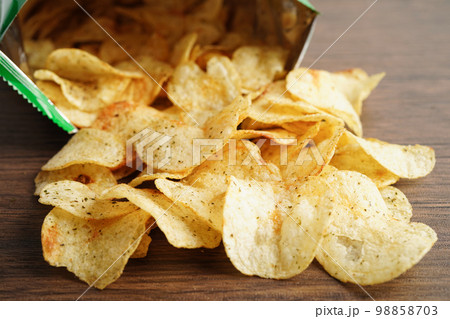 Potato chips in open bag, delicious BBQ seasoning spicy for crips, thin slice deep fried snack fast food in open bag. Potato chips in open bag, delicious BBQ seasoning spicy for crips, thin slice deep fried snack fast food in open bag. 98858703