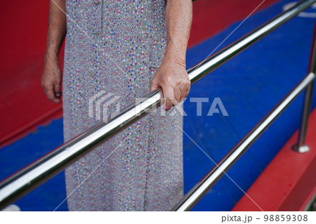 Asian elderly old woman patient use support rail on ramp, handrail safety grab bar, security in nursing hospital. Asian elderly old woman patient use support rail on ramp, handrail safety grab bar, security in nursing hospital. 98859308