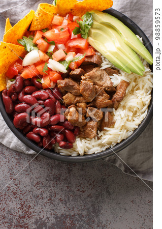 Chifrijo Costa Rican Crispy Pork, Rice and Beans closeup on the plate. Vertical top view Chifrijo Costa Rican Crispy Pork, Rice and Beans closeup on the plate. Vertical top view 98859573