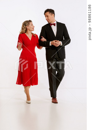 Going to festive dinner. Young man and woman, family couple in retro style clothes isolated over light background. Concept of love, relationship, retro style, creativity 98861186