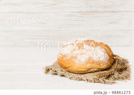 Homemade natural breads. Different kinds of fresh bread as background, perspective view with copy space Homemade natural breads. Different kinds of fresh bread as background, perspective view with copy space 98861273
