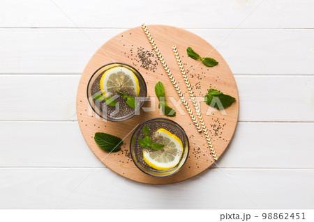 Healthy breakfast or morning with chia seeds lemon and mint on table background, vegetarian food, diet and health concept. Chia pudding with lemon and mint 98862451