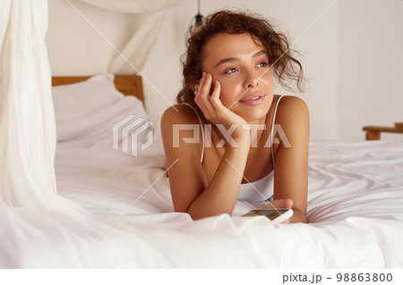 Woman Listening Music. Young Woman Using Smartphone And Earphones 98863800