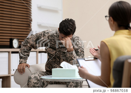 Psychotherapist working with male military officer in office Psychotherapist working with male military officer in office 98867038