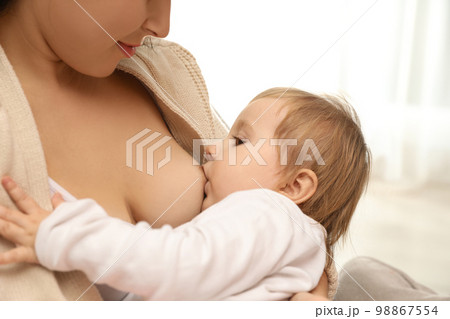 The woman feeding a baby stock image. Image of breast - 5858683