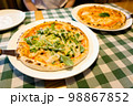 Fresh homemade authentic italian stone oven caesar pizza with arugula, sauce, grilled chicken, herbs and spicy parmesan cheese and margherita. 98867852