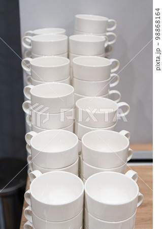 Stacks of Clean Mugs at Hotel Breakfast Buffet, White Cups Stacks of Clean Mugs at Hotel Breakfast Buffet, White Cups 98868164