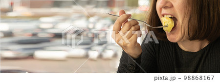 Woman eats tortellini closeup with copy space, dumpling on fork, agnolotti, cappelletti, stuffed pasta on fork Woman eats tortellini closeup with copy space, dumpling on fork, agnolotti, cappelletti, stuffed pasta on fork 98868167