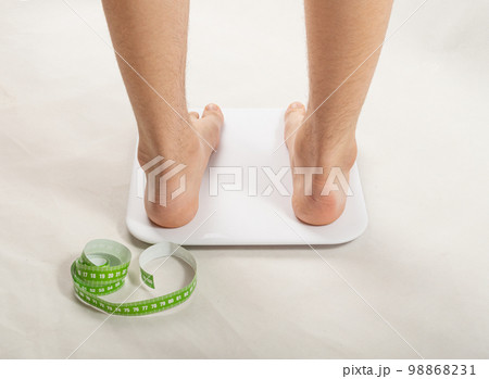 Bare Feet on Weight Scale, Overweight Control, Obese Problem, Lost Weight Concept Bare Feet on Weight Scale, Overweight Control, Obese Problem, Lost Weight Concept 98868231