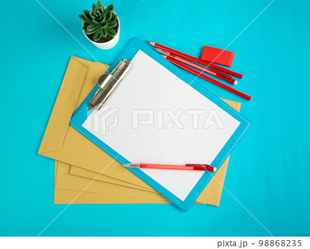 Blank Paper Tablet Top View, Empty White Sheet on Blue Table Flat Lay Mockup, Paper Tablet Texture Background Blank Paper Tablet Top View, Empty White Sheet on Blue Table Flat Lay Mockup, Paper Tablet Texture Background 98868235