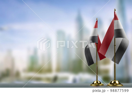 Small flags of the Yemen on an abstract blurry background 98877599