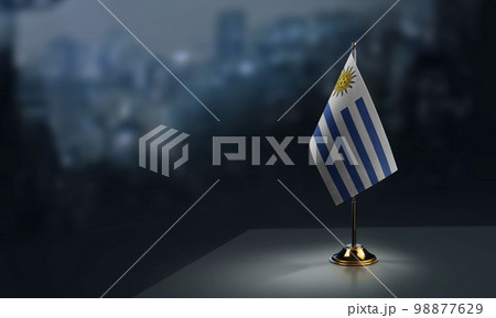 Small flags of the Uruguay on an abstract blurry background 98877629