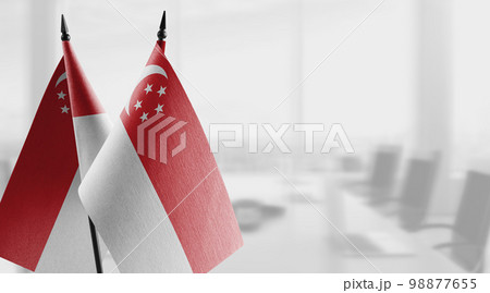 Small flags of the Singapore on an abstract blurry background 98877655