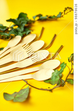 Flat lay reusable stainless steel straws and eco wooden spoons 98878616