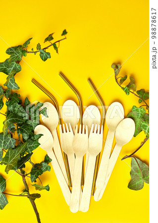 Flat lay reusable stainless steel straws and eco wooden spoons Flat lay reusable stainless steel straws and eco wooden spoons 98878617