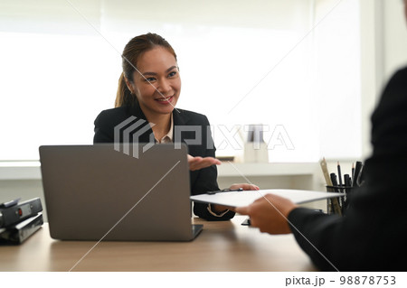 Friendly female HR manager talking negotiate with female job candidate at office meeting. Employment and recruitment concept Friendly female HR manager talking negotiate with female job candidate at office meeting. Employment and recruitment concept 98878753