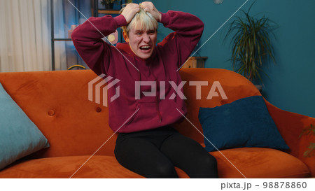 Furious woman screams from stress tension problems panic horror hopelessness fear surprise shock 98878860