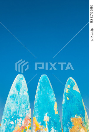 Beautiful painted surfboards on a blue sky background. Concept of active recreation and tourism. Background with copy space. 98879696
