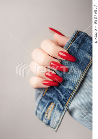 Hand of a young girl with red  manicure on nails 98879837