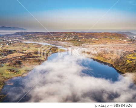Aerial view of Lough fad in the morning fog, County Donegal, Republic of Ireland 98884926