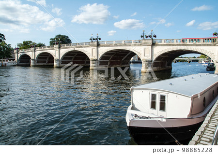 テームズ川にかかる大きい歴史的な石橋と停泊するボート　ロンドン郊外のキングストンにて 98885228