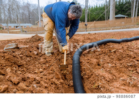 It is dig trench to lay drainage pipes during heavy downpours in order for drain rainwater It is dig trench to lay drainage pipes during heavy downpours in order for drain rainwater 98886087
