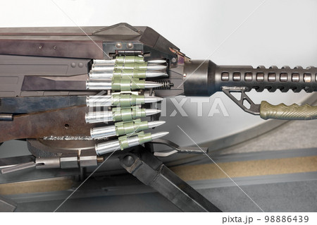 The tape with cartridges is loaded into a large-caliber machine gun. 98886439
