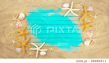 Blue boards on beach sand with starfish and shells with place for text. Banner. Vacation, travel concept. Copy space Blue boards on beach sand with starfish and shells with place for text. Banner. Vacation, travel concept. Copy space 98886811