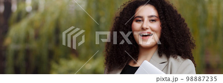 Banner business woman holds a glass of coffee in her hands 98887235