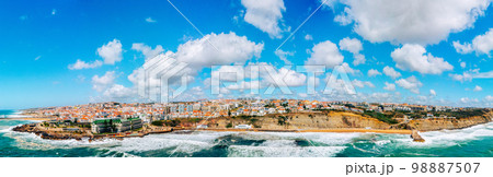 Beautiful oceanscape panorama with skyline, ocean rocky coastline. Drone view over beaches, coastlines in Ericeira, Portugal, on summer sunny day. Aerial view to the Beautiful European touristic town. 98887507