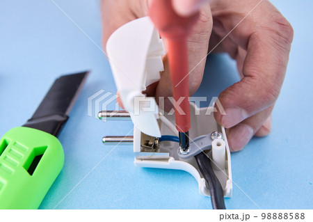 Electrical cord is connected to folding electric plug and secured with fixing screw. 98888588