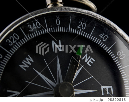 Close-up silver compass on a black background 98890818