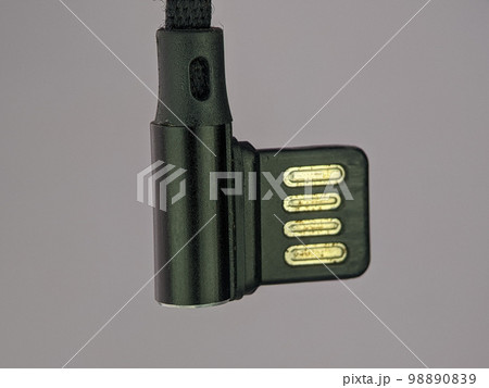 Closeup black usb charger cable on a gray background. 98890839