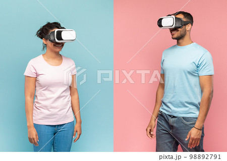 Black man and woman in VR headset experiencing virtual reality, standing over halved pink and blue background 98892791