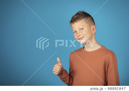 Portrait Of Smiling Preteen Boy Showing Thumb Up At Camera 98892847