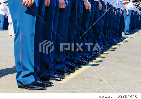 feet of squad of policemen in boots on line 98894440