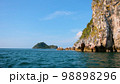 view of the five Tyrrhenian sea coast of Capri, Italy. Rocky cliffs, blue water, floating boats, greenery 98898296