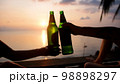 Hands of happy friends cheering celebrating holidays with wine during the epic sunset. Slow Motion. 98898297