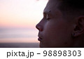 Thoughtful guy on the beach during sunset 98898303