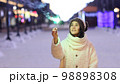 Portrait of young smiling Caucasian woman holding sparklers. Happy cheerful girl outdoors Celebrating New Year holidays vacation. Xmas Christmas winter atmosphere. 3840x2160 98898308