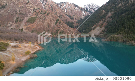 Dark blue mirror color of water in a mountain lake 98901090