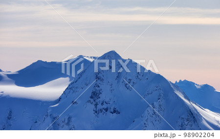 Snow and Cloud covered Canadian Nature Landscape Mountains Background. Whistler Snow and Cloud covered Canadian Nature Landscape Mountains Background. Whistler 98902204