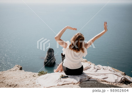 Woman sea laptop. Successful business woman working on laptop by the sea. Pretty lady typing on computer at summer day outdoors. Freelance, digital nomad, travel and holidays concept. Woman sea laptop. Successful business woman working on laptop by the sea. Pretty lady typing on computer at summer day outdoors. Freelance, digital nomad, travel and holidays concept. 98902604